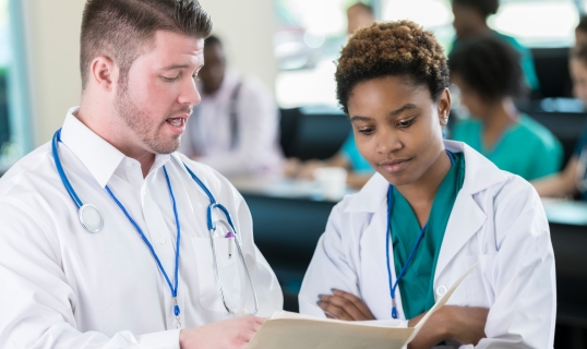 physician providing feedback to medical school resident