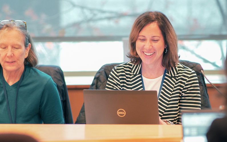 creative community members sitting in meeting