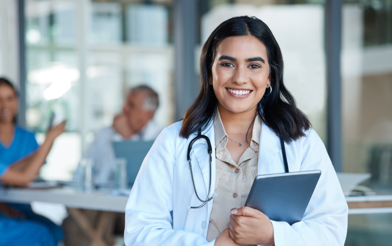 medical student holding tablet and smiling