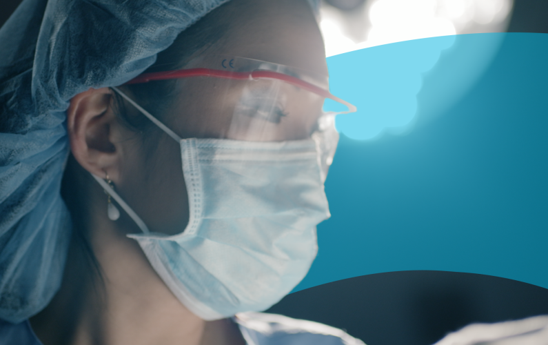 close-up of a surgeon wearing a mask and safety glasses