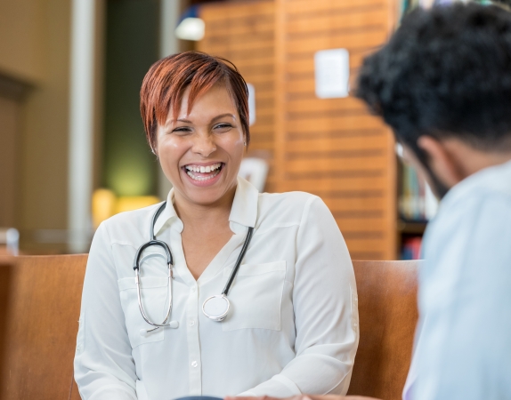 Doctor smiling with talking to someone