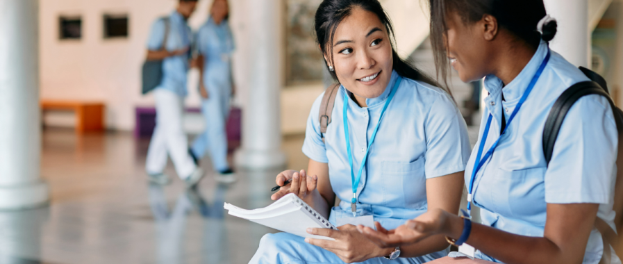 Two medical students talking to each other.