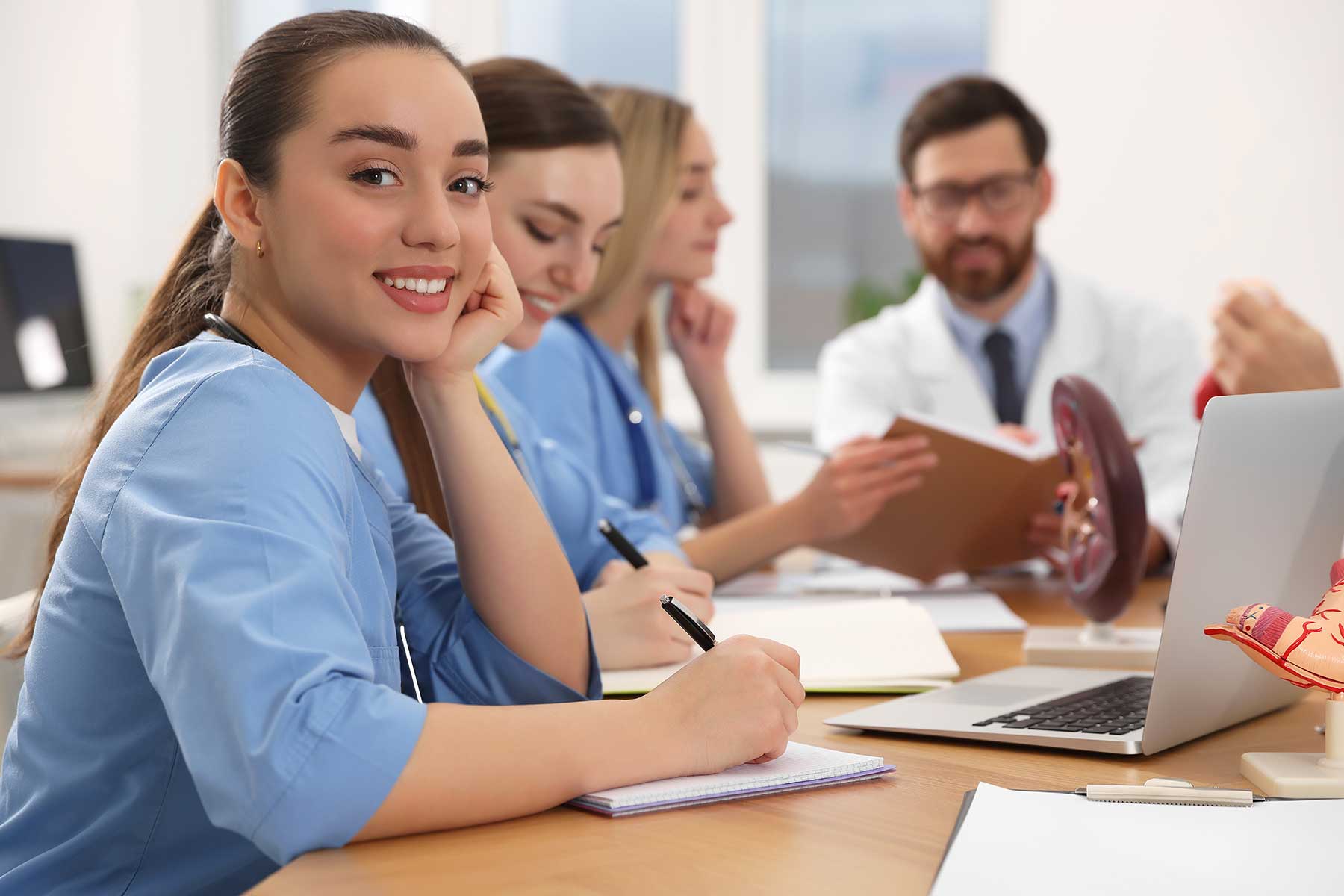 Medical students studying with a doctor